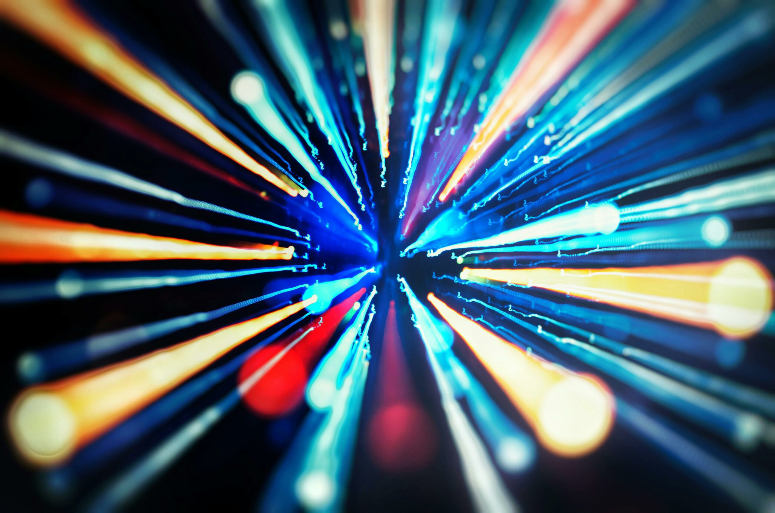 Vivid abstract blur of colorful light streaks in motion creating a dynamic visual effect.